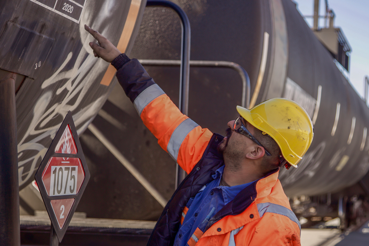 Harbor Employee pointing at a tank car